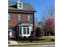 Beautiful brick home with manicured lawn, American flag, and elegant bay window at 216 Harrison Ln # 4, Locust, NC 28097