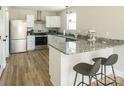 Modern kitchen featuring granite countertops, stainless steel appliances, and a breakfast bar with seating at 2313 Glenwood St, Kannapolis, NC 28083