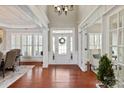 Grand foyer with hardwood floors, soaring ceilings, and elegant chandelier creates a welcoming entry at 2610 Creek Manor Dr, Waxhaw, NC 28173