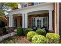 Inviting front porch with stone columns and white trim, perfect for relaxing and enjoying the outdoors at 2610 Creek Manor Dr, Waxhaw, NC 28173
