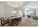 Open-concept dining room and living room with carpet and fireplace at 2959 Bellasera Way, Matthews, NC 28105