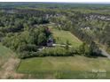 Expansive property featuring a brick home, detached garage with pool and sprawling green landscape at 3677 Antioch Church Rd, Matthews, NC 28104