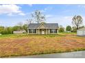 Inviting single-story home with a classic design, black shutters, and freshly manicured lawn at 391 Springs East Rd, Lincolnton, NC 28092