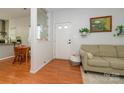 Inviting foyer with hardwood floors, neutral decor, and a view into the dining area and adjacent living space at 4133 Carl Parmer Dr, Harrisburg, NC 28075