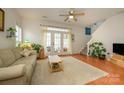 Bright living room featuring hardwood floors, neutral walls, and French doors to a patio, creating a welcoming atmosphere at 4133 Carl Parmer Dr, Harrisburg, NC 28075
