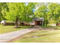A cozy brick house with an attached carport and a driveway, shaded by a mature tree at 510 N Jackson Rd, Lancaster, SC 29720