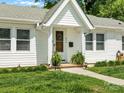 A welcoming porch featuring a classic wooden door, ferns, and freshly cut green lawn at 512 Secrest Ave, Belmont, NC 28012