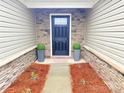 Inviting front entryway with decorative stone accents and welcoming doormat at 531 Cherry Blossom Nw Ave, Concord, NC 28027