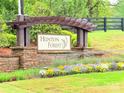 Hunton Forest community sign with stone base and colorful flowerbed at 531 Cherry Blossom Nw Ave, Concord, NC 28027