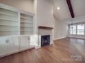 Open living area showcasing fireplace with built-in shelving and wood mantle at 5604 Unionville Rd, Monroe, NC 28110