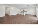 Bright living room featuring stylish wood flooring and easy access to the kitchen area at 561 Mountain View Dr, Monroe, NC 28110