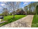 Well-maintained yard with long driveway and a basketball hoop leading up to the brick home at 591 Highland Ridge Rd, Mooresville, NC 28115