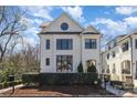 Beautiful white brick home boasts a stylish design with a round accent window at 728 Brookside Ave, Charlotte, NC 28203