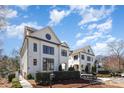 Elegant white brick homes offer modern luxury with distinctive round windows and clean lines at 728 Brookside Ave, Charlotte, NC 28203