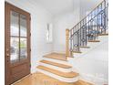 Bright foyer with wood floors, shiplap walls, and a staircase with modern railing at 728 Brookside Ave, Charlotte, NC 28203