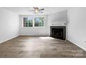 Bright, open living room with fireplace, large windows and neutral decor, perfect for relaxation at 7301 Pebblestone Dr # F, Charlotte, NC 28212