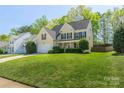 Beautiful home featuring lush green lawn, attached garage, and black shutters at 7353 Sedgebrook W Dr, Stanley, NC 28164