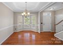 Bright dining room featuring hardwood floors, bay windows and elegant chandelier at 831 Daly Cir, Fort Mill, SC 29715