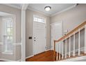 Inviting foyer featuring hardwood floors and a staircase with wooden railings at 831 Daly Cir, Fort Mill, SC 29715