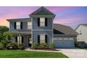 Charming two-story home with gray siding, black shutters, a two-car garage, and a manicured front lawn at 1003 Dorsey Dr, Fort Mill, SC 29715