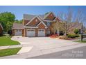 Beautiful two-story brick home with a three-car garage and a spacious driveway at 10104 Silverling Dr, Waxhaw, NC 28173