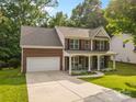 Beautiful two-story brick home with a covered front porch and a spacious driveway at 1014 Sandbox Cir, Indian Trail, NC 28079