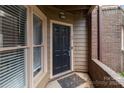 Close-up of a front door with storm door and sidelight window at 1109 E Morehead St # 22, Charlotte, NC 28204