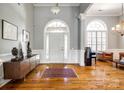 Elegant foyer with high ceilings, arched windows, hardwood floors, and stylish decor at 1126 Blowing Rock Cv, Fort Mill, SC 29708