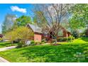 Beautiful brick home with lush green lawn and mature trees in a neighborhood setting at 1126 Blowing Rock Cv, Fort Mill, SC 29708