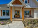 Inviting front porch with wooden pillars and double front doors at 1160 Springlake Rd, York, SC 29745