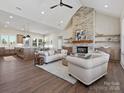 Open living space with stone fireplace, wood floors, and vaulted ceiling at 1160 Springlake Rd, York, SC 29745