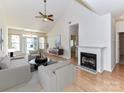 Bright living room featuring a fireplace, hardwood floors, vaulted ceiling, and neutral color palette at 11705 Silverado Ln, Charlotte, NC 28277