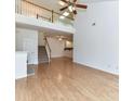 Spacious living room featuring wood floors, high ceilings, and staircase to the second story loft at 11705 Silverado Ln, Charlotte, NC 28277