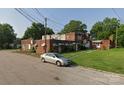 Brick exterior with multiple entrances, small lawns, and off-street parking space at 1205 W Bank St, Salisbury, NC 28144