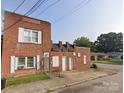 Brick multi-unit home with white framed windows and several entrances along the front at 1205 W Bank St, Salisbury, NC 28144