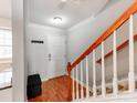 Inviting entryway with wood floors, staircase and coat hooks at 1217 Green Oaks Ln # K, Charlotte, NC 28205