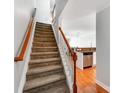 Carpeted staircase leading to an open floor plan with wood floors and stainless steel appliances at 1217 Green Oaks Ln # K, Charlotte, NC 28205