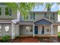 Charming two-story townhome with covered front porch and neutral siding at 12925 Windy Lea Ln, Huntersville, NC 28078