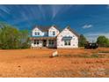 New construction home with builder wrap, showcasing the two-story structure, set on a spacious lot at 1504 Baileys Run, Gastonia, NC 28056