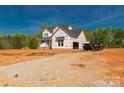 Image of a home under construction, revealing the building's structure and layout on a wide lot at 1504 Baileys Run, Gastonia, NC 28056