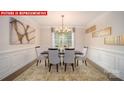 Elegant dining room with wainscotting and an ornate chandelier above the table at 156 Asmodean Ln, Troutman, NC 28166