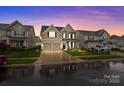Inviting two-story home with a two-car garage, manicured lawn and a cozy front porch at 187 Longleaf Dr, Mooresville, NC 28117
