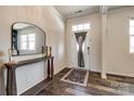 Elegant home entryway with hardwood floors, a stylish mirror, and a charming rug, creating a welcoming ambiance at 19010 Hawk Haven Ln, Charlotte, NC 28278