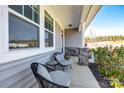 Inviting front porch featuring comfortable seating and decorative stone supports, perfect for enjoying the outdoors at 19010 Hawk Haven Ln, Charlotte, NC 28278