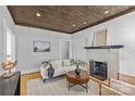Bright living room features a decorative fireplace, hardwood floors, and neutral color palette at 2125 Kenilworth Ave, Charlotte, NC 28203