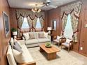 A professionally staged living room features updated furniture, rug, and decor at 215 Old Dixie Rd, Lancaster, SC 29720