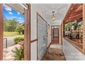 Charming hallway with stone floors, wooden trim, and a view of a cozy study at 2281 Old Salisbury Concord Rd, Concord, NC 28025