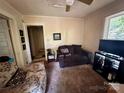Cozy living room featuring a plush sofa and natural light from the window at 267 Hall Nw Ave, Concord, NC 28027