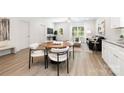 Open-concept living area with modern dining set, sleek seating, and bright natural light at 327 Lincoln Sw St, Concord, NC 28025