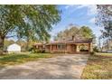View of this quaint home featuring a covered carport and cozy front porch, and mature trees overhead at 3320 28Th Ne St, Hickory, NC 28601
